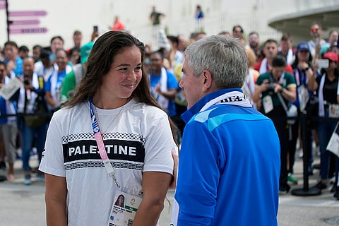 Thomas Bach talks to Palestinian athlete Valerie Rose Tarazi
